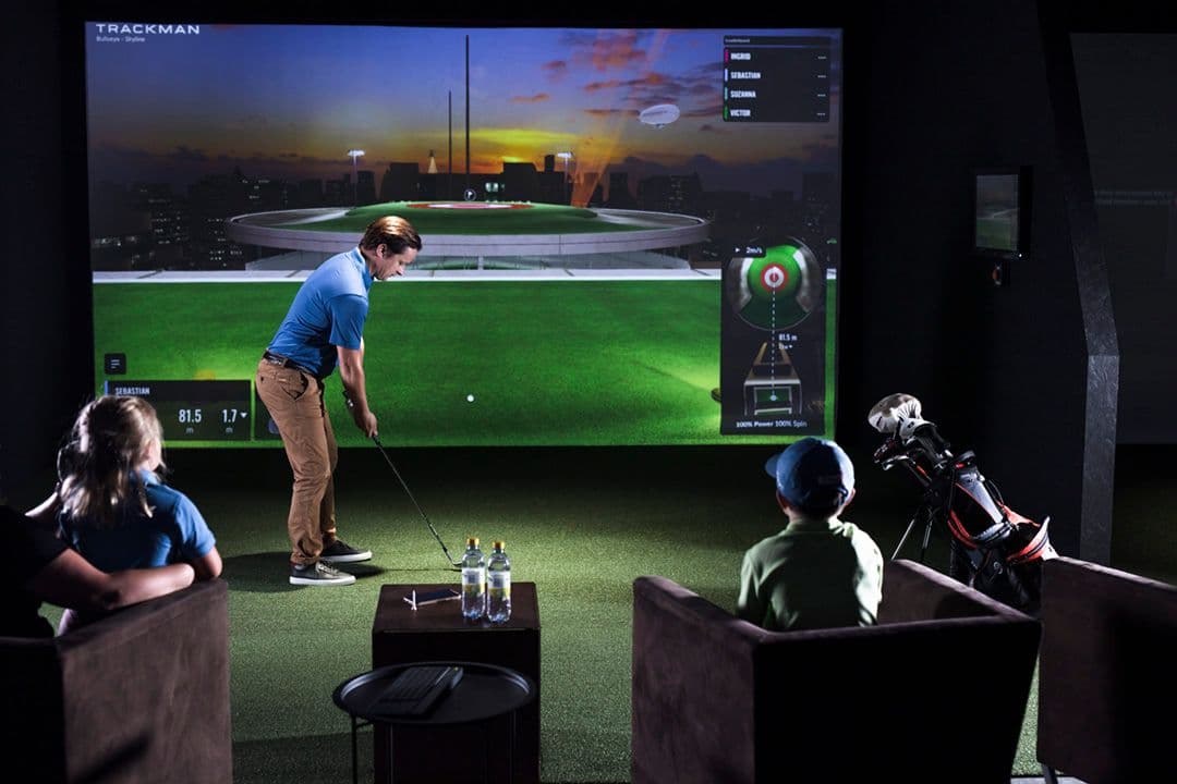 Finished home golf simulator enclosure with impact screen